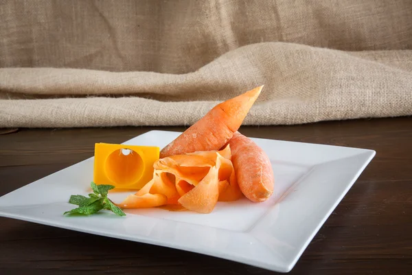 Peeled carrots with sharpener — Stock Photo, Image
