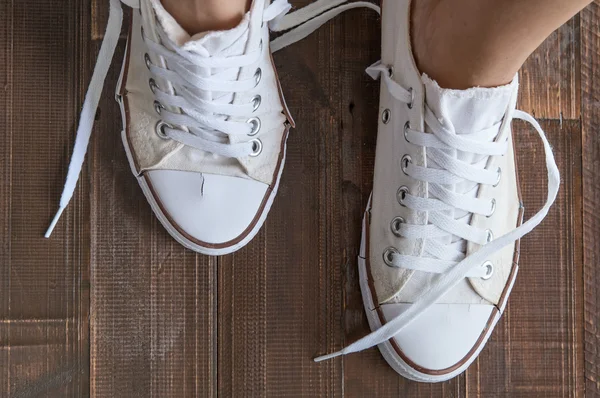 Retro sneakers left on wooden floor — Stock Photo, Image