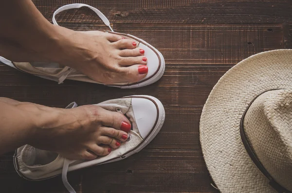 Retro sneakers left on wooden floor — Stock Photo, Image