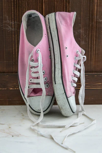 Retro sneakers left on wooden floor — Stock Photo, Image