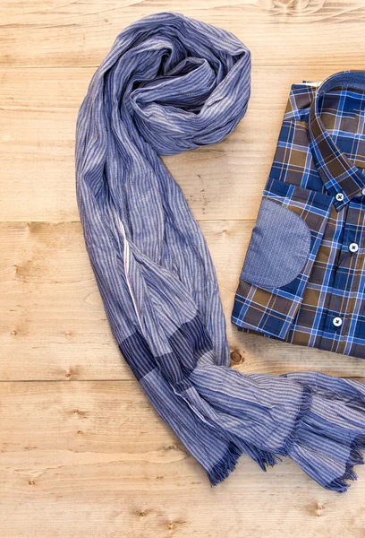 Shirt and scarf on wooden board — Stock Photo, Image