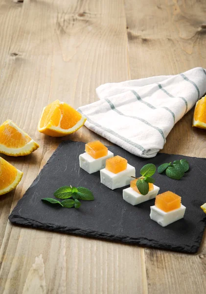 Snack cheese with quince and fresh oranges — Stock Photo, Image