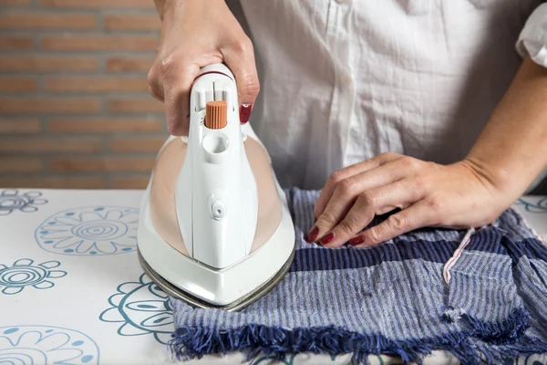 Middle-aged woman ironing — Stock Photo, Image