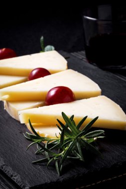 Manchego cheese with grapes, mint and rosemary clipart