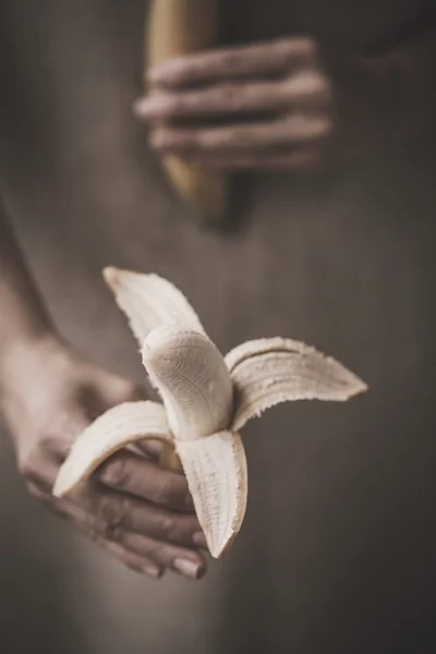 Close-up of hand holding delicious banana — Stock Photo, Image