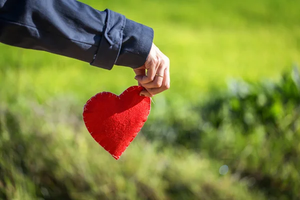 Nahaufnahme der Hand, die ein rotes Herz hält — Stockfoto