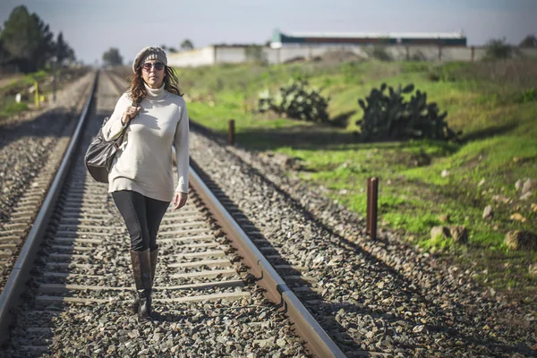 Vrouw wandelen langs de spoorweg — Stockfoto