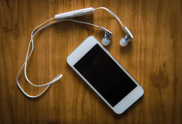 Headphones and phone — Stock Photo, Image