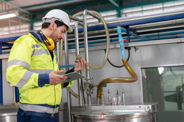 Machine engineers inspect machines and sterilizers in food factories or factory drinking water plants. Machine maintenance