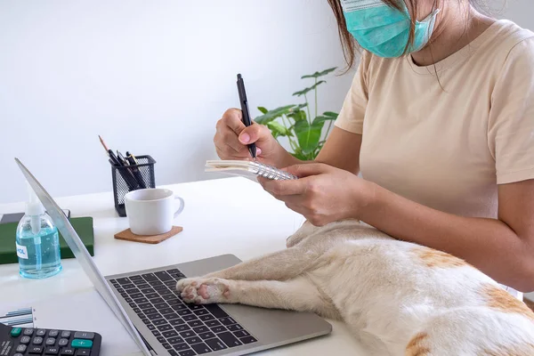 Women work in the house with their pets. concept of working from home and social distance