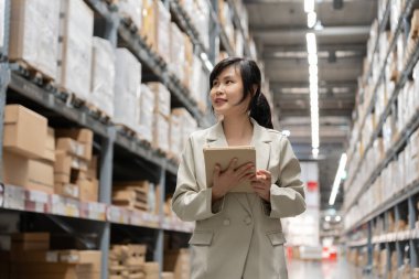 portrait female business owner using digital tablet check amount of stock product inventory on shelf at distribution warehouse factory.logistic business ship and delivery, inventory flow, professional