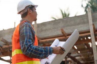 Müfettiş ya da mühendis mavi baskı kullanarak inşaat ve kalite güvencesini denetliyor. Mühendis, mimar ya da irtibat kurucu ev sahibine teslim etmeden önce evi inşa etmek için çalışır.