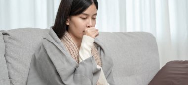 sick woman with a headache sitting under blanket, female sneezing and runny nose with seasonal influenza, allergic, high fever and influenza, resting, virus, coronavirus, feel illness, respiratory