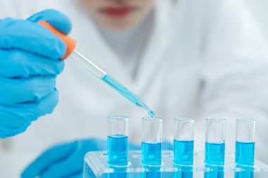 Scientist analyze biochemical samples in advanced scientific laboratory. Medical professional use dropper mix microbiological developmental of viral. Biotechnology research in  science lab. cosmetic