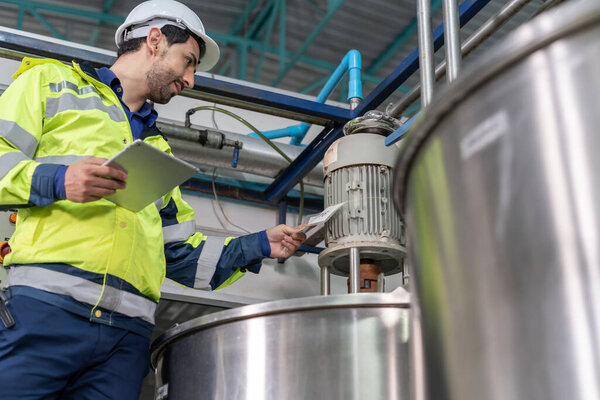 Engineers or utility staff wearing safety helmet fix the machines in the production line. Utility inspector check machine and test the system to meet the standard. machine, Preventive Maintenance