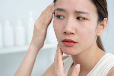 Young woman are worried about faces Dermatology and allergic to steroids in cosmetics. sensitive skin, red face from sunburn, acne, allergic to chemicals, rash on face. skin problems and beauty