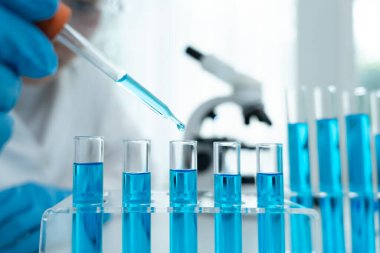 Scientist analyze biochemical samples in advanced scientific laboratory. Medical professional use dropper mix microbiological developmental of viral. Biotechnology research in  science lab. cosmetic