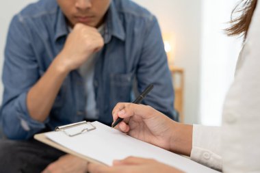 man with mental health problems is consulting. psychiatrist is recording the patient's condition for treatment. encouragement, love and family problem, bipolar , depression patient, protect suicide