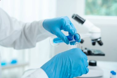 Scientist analyze biochemical samples in advanced scientific laboratory. Medical professional use dropper mix microbiological developmental of viral. Biotechnology research in  science lab. cosmetic