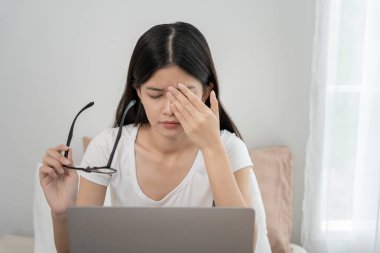 Göz sorunları, yorgun ve tahriş olmuş gözleri olan Asyalı kadınlar, göz ovuşturma, kuru, işten sonra göz ağrısı, migren, baş ağrısı, bulanık görme, karanlıkta çalışma, bilgisayardan gelen mavi ışık. 