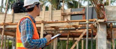inspector or engineer is inspecting construction and quality assurance new house using a checklist. Engineers or architects or contactor work to build the house before handing it over to the homeowner