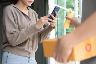 Happy Asian woman scan QR code for pay goods delivery. Delivery man send deliver express. online shop, paper container, takeaway, postman, delivery service, packages, electronic money, Digital transfe