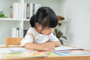 Mutlu Asyalı çocuklar evde kitap okuyarak rahatlar. Kızım ve bir hikaye okuyordum. öğrenme, çocuk bakımı, gülme, eğitim, hikaye anlatma, uygulama, hayal etme, bağımlılık cep telefonunu azaltma