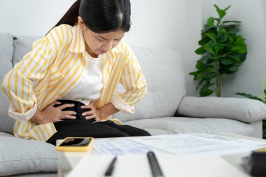 stomach ache. Asian women have abdominal pain, indigestion, gastritis, menstrual cramps, flatulence, diarrhea, distention, colon cancer, belly inflammation problem, suffer food poisoning, abdomen