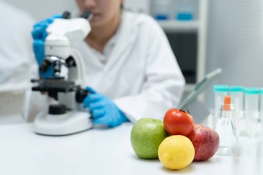 Scientist check chemical food residues in laboratory. Control experts inspect quality of fruits, vegetables. lab, hazards, ROHs, find prohibited substances, contaminate, Microscope, Microbiologist