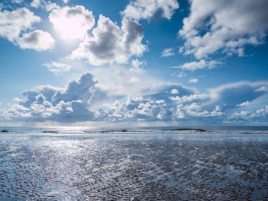 Cloudscape on the beach at the North Sea clipart