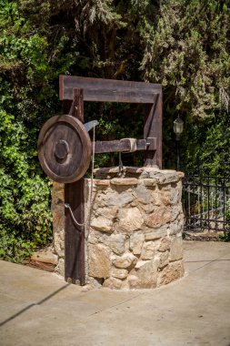 Stone water well with winch near the entrance to the archaeological park of Shiloh, Israel clipart