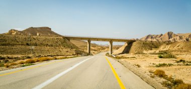 The Makhtesh Gadol, road and bridge in Negev desert, Israel clipart