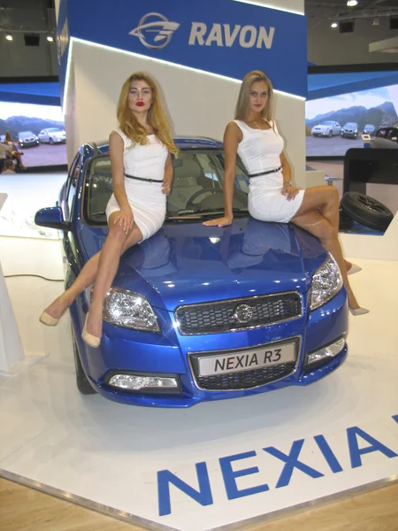 Girl model sitting on the hood of Nexia R3. Moscow International Auto Show 2016. — Stock Photo, Image