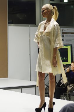 Intercharm XXI International Perfumery and Cosmetics Exhibition Lingrie Expo Traffic Young beautiful blonde in a light lemon dressing gown Look