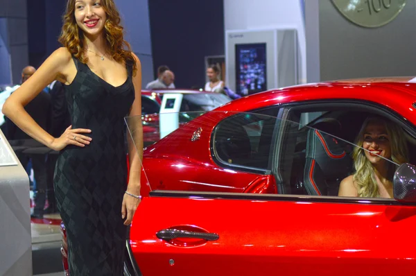 Young womens from Team Maserati. Gran Turismo. Red car Look Moscow International Automobile Salon Premium — Stock Photo, Image