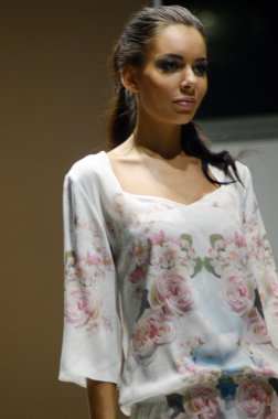 Moscow Traffic 5th International Exhibition of underwear, beachwear, home wear and hosiery Lingrie Expo Young brunette woman in a negligee with roses