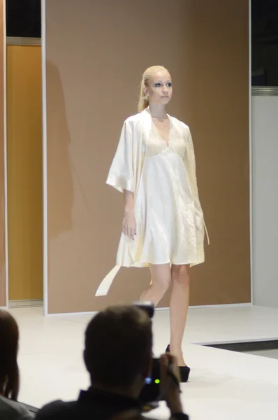 Young woman in white and yellow nightgown 5th International Exhibition of underwear, beachwear, home wear and hosiery — Stock Photo, Image