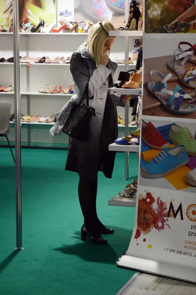 Woman chooses shoes Fashionable shoes International specialized exhibition for footwear, bags and accessories Mos Shoes Moscow — Stock Photo, Image