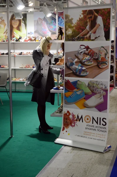 Nainen valitsee kengät Muodikas kengät Kansainvälinen erikoisnäyttely jalkineille, laukuille ja asusteille Mos Shoes Moscow Shopping — kuvapankkivalokuva