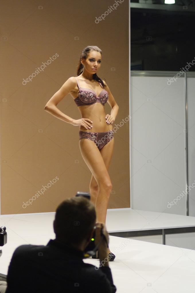 Moscow Traffic 5th International Exhibition of underwear, beachwear, home wear and hosiery Lingrie Expo Young beautiful brunette woman in a colorful satin lingerie with flowers