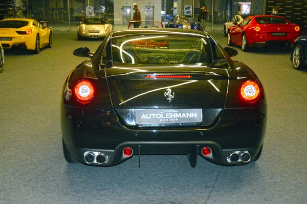 Ferrari color wet asphalt in the showroom — Stock Photo, Image