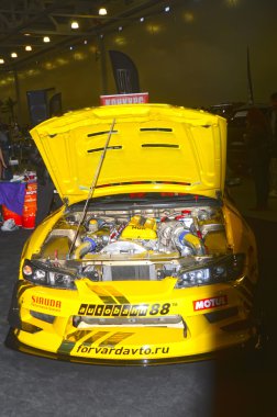 Moskova Tuning Show 2015. Açık kaput ile sarı yarış arabası