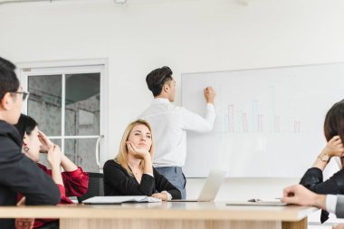 İş adamları, şirket toplantı odalarında problemleri çözmek için beyin fırtınası yapıyorlar..