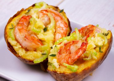 Stuffed potato with shrimps, celery, cheese and thyme clipart