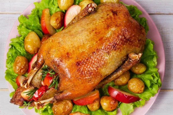 Canard rôti aux pommes de terre, pommes, salade, thym et romarin — Photo