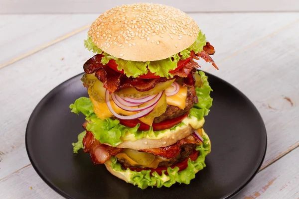 Burger Med biff, bacon, tomat, ost, salat og løk – stockfoto