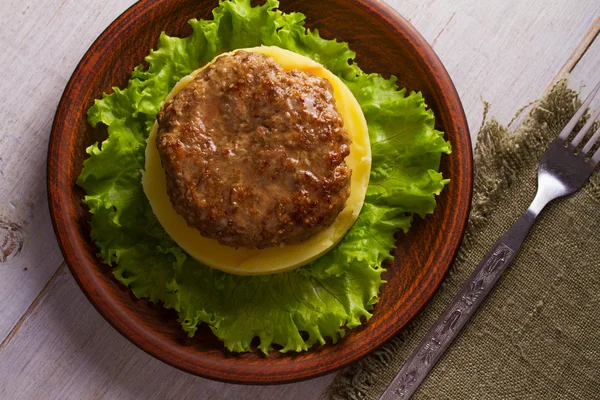 Beef and pork patty with smashed potato and lettuce
