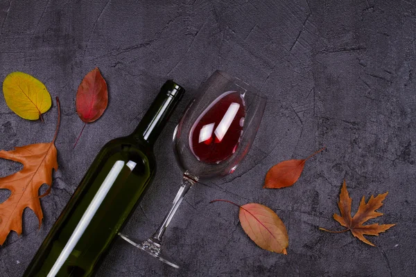 Bicchiere e bottiglia di vino rosso e bianco. Uva e noci su sfondo nero — Foto Stock