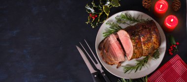 Roasted beef. Christmas decorations. New Year dinner table. View from above, top studio shot, copy space clipart