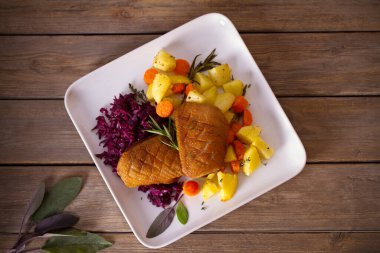 Kızarmış ördek göğsü fileto patates, havuç, kırmızı lahana ve bitkilerle. başlığın üzerinde yatay konum
